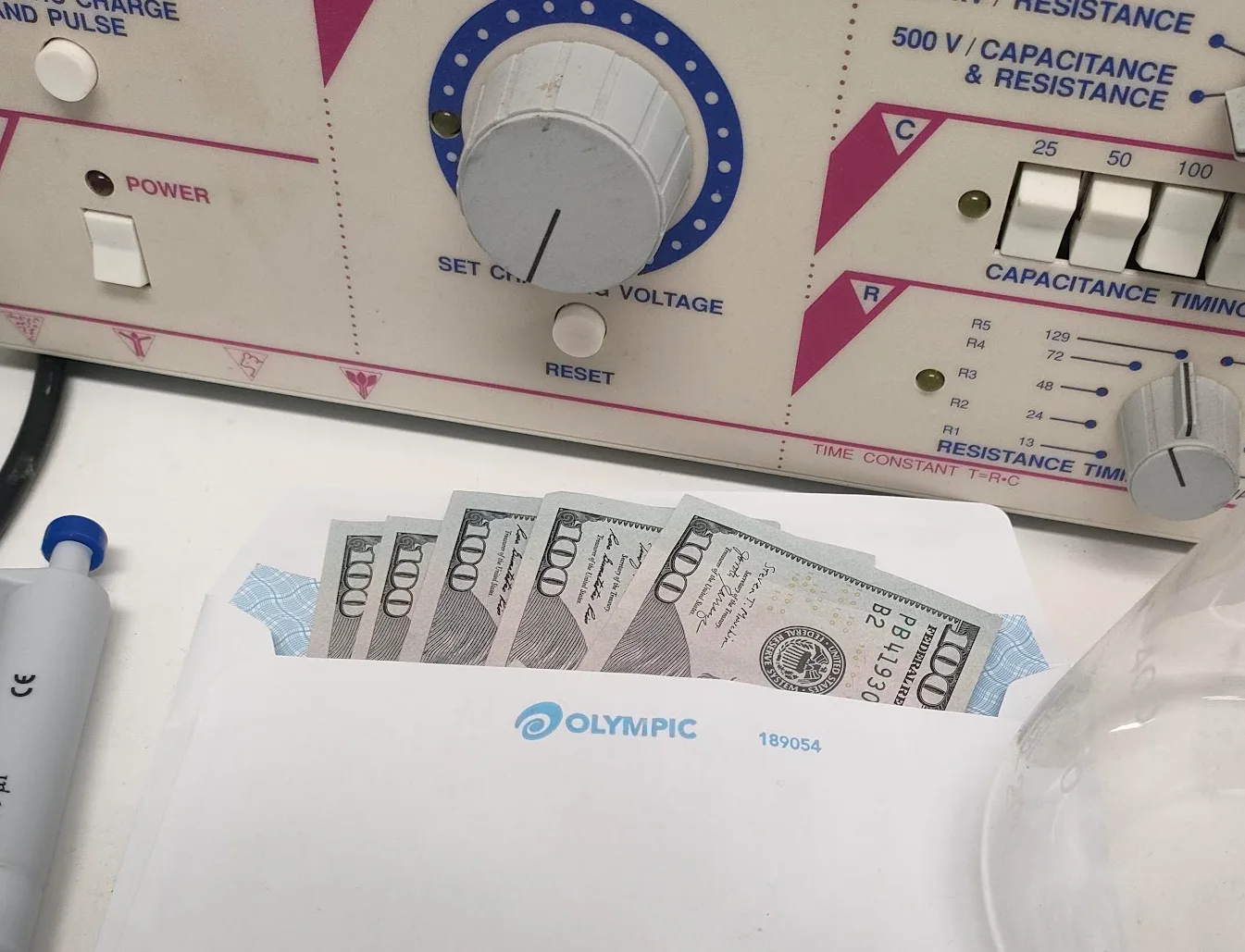 Five hundred US dollars in an envelope on a biomedical laboratory bench